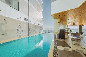 a large swimming pool in a building at The Zenix Hotel Seaview in Nha Trang