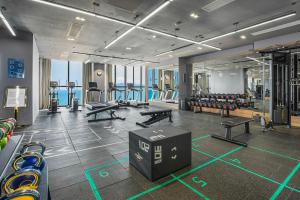 a gym with a bunch of treadmills and machines at The Zenix Hotel Seaview in Nha Trang