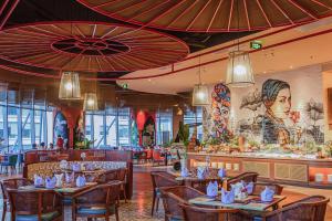 a restaurant with tables and chairs and a bar at The Zenix Hotel Seaview in Nha Trang