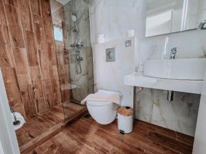a bathroom with a shower and a toilet and a sink at Meraki Nikiti in Nikiti