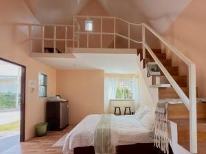 a bedroom with a bed and a staircase at silverpine khao kho in Phetchabun
