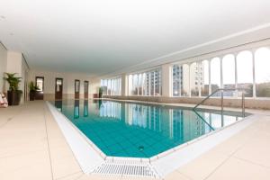 a large swimming pool in a building with windows at Lord Nelson 119 in Döse +11 photos
