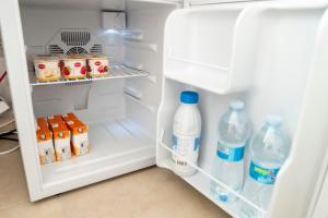 an open refrigerator filled with milk and water at Bed And Breakfast Nonna Pia in Fertilia