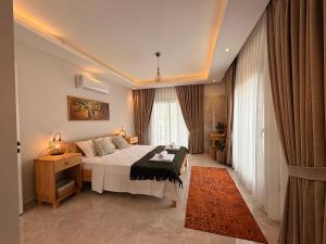 a hotel room with a bed and a window at As Villas Villa Asil in Fethiye +24 photos