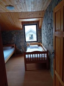 a small room with two beds and a window at Kompleks Gurman in Pʼklište