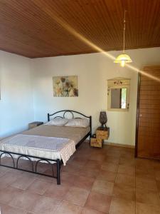 a bedroom with a bed and a wooden ceiling at Villa canty in Nea Potidaea