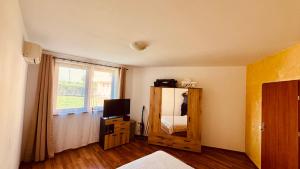 a bedroom with a mirror and a bed and a window at EGGO APARTMENT - Oasis Beach Apartments Kamchia in Dolen Bliznak