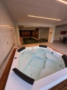 a jacuzzi tub in a room at Hotel Recanto da Serra in Gramado