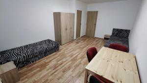 a room with two beds and a table and chairs at Apartmán pro 6 osob, Most M2 in Most +17 photos