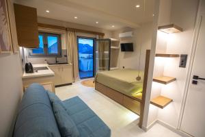 a bedroom with a bed and a couch in a room at Themelina Studios in Emborios