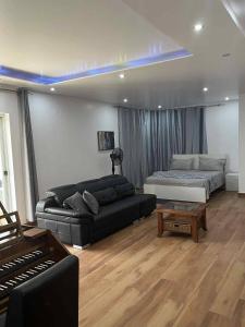 a living room with a couch and a bed at Residência Águia in Praia +61 photos