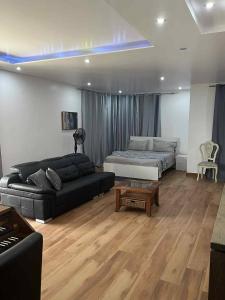 a living room with a couch and a bed at Residência Águia in Praia
