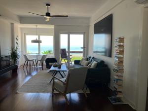 a living room with a couch and a table at Oceanview 4 U - Close to Lisbon! in Oeiras