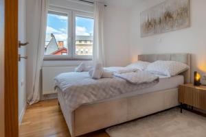 a bedroom with a bed with a stuffed animal on it at Aurea Lika - Gospic in Gospić