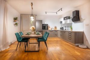 a kitchen and dining room with a table and chairs at Aurea Lika - Gospic in Gospić