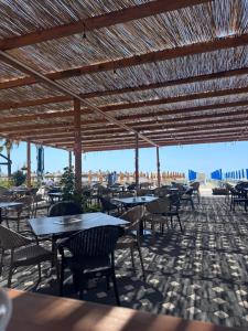 a patio with tables and chairs with a view of the city at Elite Hotel in Golem