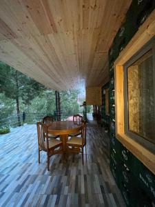 a dining room with a wooden table and chairs at Bovilla Canyon1 in Tirana