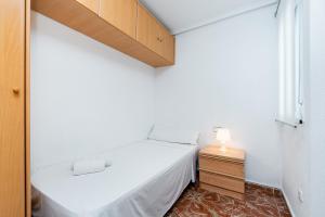 a small bedroom with a bed and a window at Sunrise Arts 1 in Torrevieja