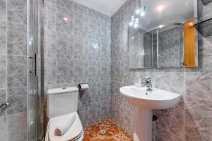 a bathroom with a toilet and a sink and a shower at Sunrise Arts 1 in Torrevieja +11 photos