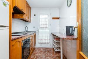 a small kitchen with a sink and a counter at Sunrise Arts 1 in Torrevieja