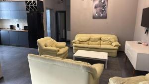 a living room with two couches and a table at Mari's Villa in Batumi