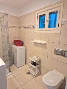 a bathroom with a toilet and a window at Casa Balcón del Puerto in Playa Blanca +29 photos