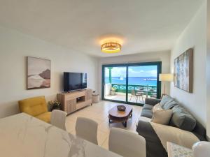 a living room with a couch and a television at Casa Balcón del Puerto in Playa Blanca