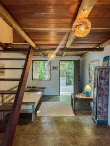 a living room with a bunk bed and a staircase at Pousada Aratu - Vila de Caraíva - A apenas 100 metros da travessia de canoa in Caraíva