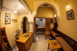 a living room with a couch and a bed at Dar al haja rahma in Fez