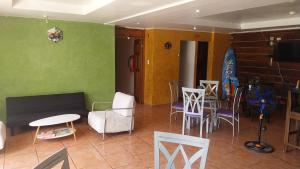 a living room with a couch and a table and chairs at Hotel Calle 6 in Bocas Town
