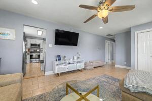 a living room with a couch and a ceiling fan at Shore Escape Steps to the Beach in Ventnor City