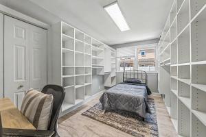 a bedroom with a bed and a desk and shelves at Shore Escape Steps to the Beach in Ventnor City