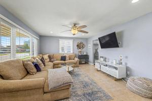 a living room with a couch and a flat screen tv at Shore Escape Steps to the Beach in Ventnor City