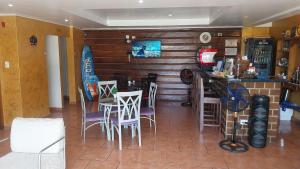 a bar with chairs and a table in a room at Hotel Calle 6 in Bocas Town