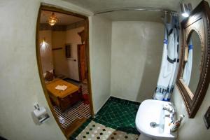 a bathroom with a sink and a mirror at Dar al haja rahma in Fez +57 photos