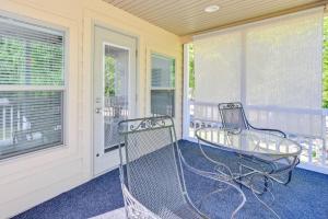 a porch with two chairs and a glass table at Pool & Lake Access! Sherrills Ford Tiny Home in Sherrills Ford