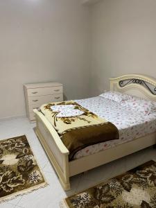 a bedroom with a bed and a dresser and two rugs at Flag's Square House Vlore in Vlorë