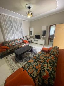 a living room with a couch and a table at Flag's Square House Vlore in Vlorë