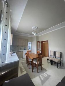 a kitchen and dining room with a table and chairs at Flag's Square House Vlore in Vlorë