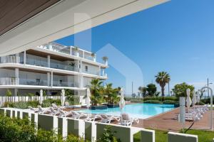 a resort with a swimming pool and lounge chairs at Homiday - WaterFront Roseto in Roseto degli Abruzzi