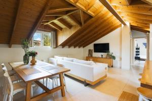 a living room with a white couch and a table at The Hidden Attique in Corfu