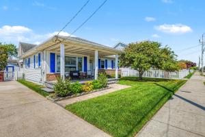 a blue house with a fence and a yard at Shore Escape Steps to the Beach in Ventnor City