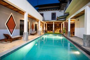 a swimming pool in a villa with a house at Serenity Lake Front Villa in Moratuwa