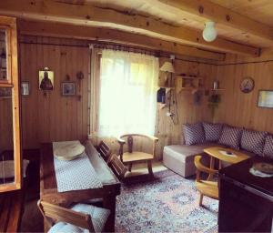 a living room with a couch and a table at Black Lake House Dajovic in Žabljak