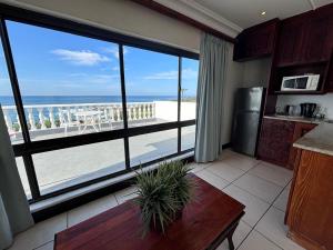 a kitchen with a large window with a view of the beach at Gracelands Beach Lodge in Ramsgate