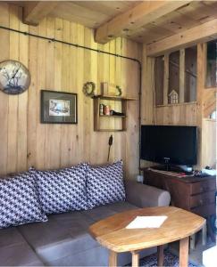 a living room with a couch and a table at Black Lake House Dajovic in Žabljak