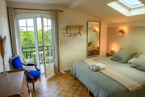 a bedroom with a bed and a desk and a window at Amama Baita in Urrugne