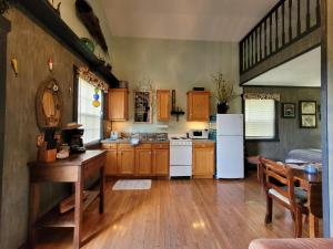 a kitchen with wooden cabinets and a white refrigerator at FireFly Acres in Sparta