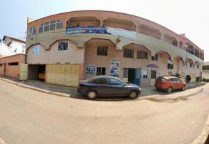 two cars parked in front of a building at The Yafé Bastos 9 in Yaoundé