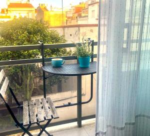 a table with two cups and a plant on a balcony at Sitges Center & Beach Espalter in Sitges